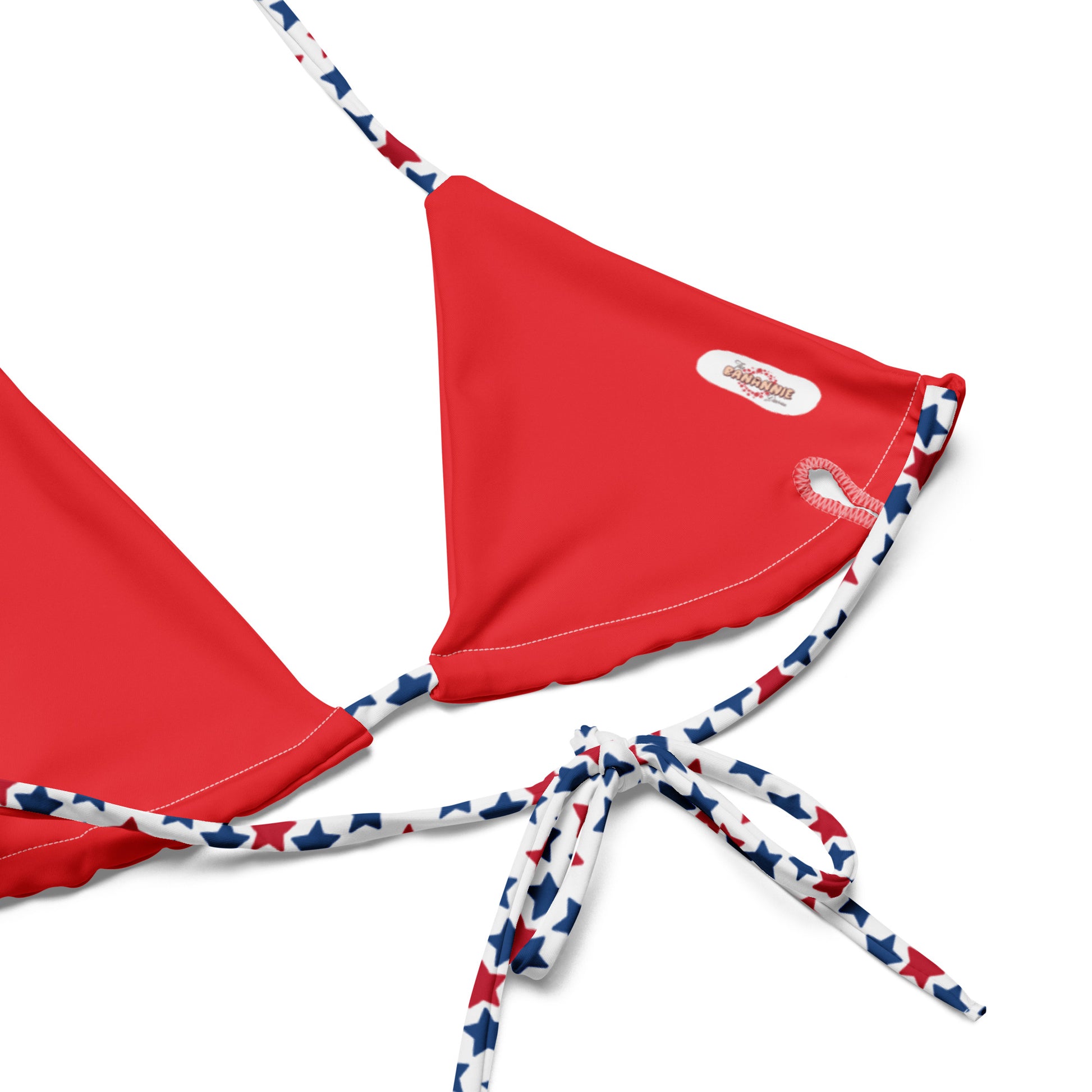 Elevate your swimwear collection with our Red, White, And Stars All-Over Print Recycled String Bikini Top. This stylish and eco-friendly top features a vibrant star pattern that’s perfect for showcasing your patriotic spirit. Made from recycled materials, it offers both fashion and sustainability. The adjustable string ties provide a customized fit, ensuring comfort for all your beach or poolside adventures.