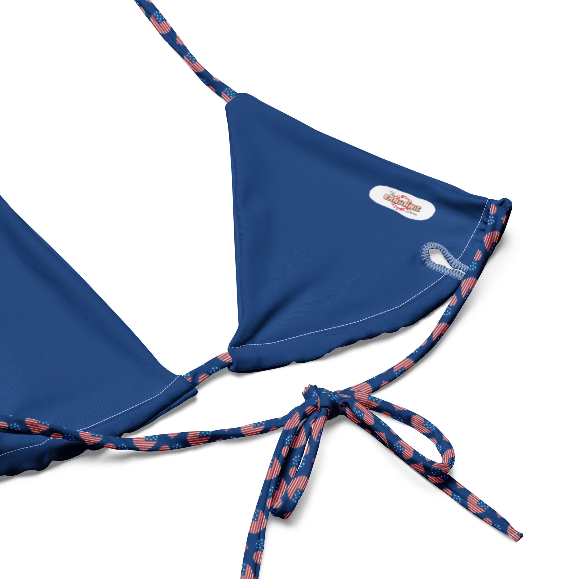 Elevate your swimwear collection with our American Hearts All-Over Print Recycled String Bikini Top. This stylish and eco-friendly top features a vibrant heart pattern that’s perfect for showcasing your patriotic spirit. Made from recycled materials, it offers both fashion and sustainability. The adjustable string ties provide a customized fit, ensuring comfort for all your beach or poolside adventures.