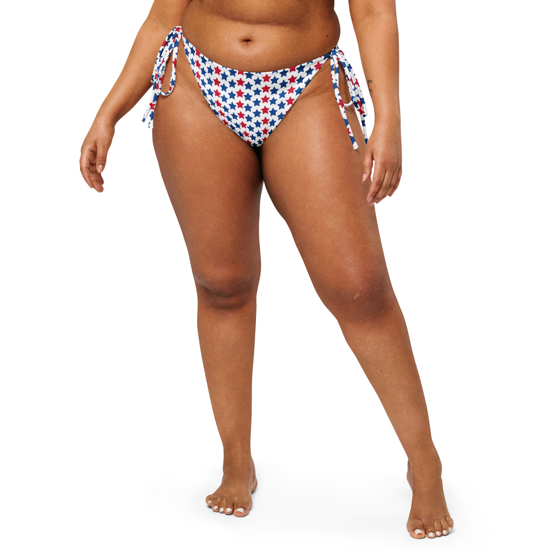 Discover our Red, White, And Stars Recycled String Bikini Bottom, a chic and sustainable swimwear option perfect for showing your patriotic spirit. Crafted from eco-friendly recycled materials, this bikini bottom features stars in vibrant colors of red and blue. Ideal for beach days or poolside lounging, its adjustable string ties ensure a perfect fit.