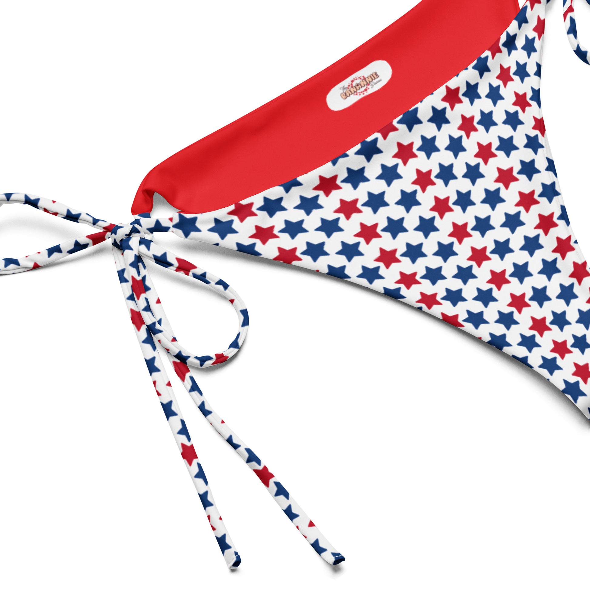 Discover our Red, White, And Stars Recycled String Bikini Bottom, a chic and sustainable swimwear option perfect for showing your patriotic spirit. Crafted from eco-friendly recycled materials, this bikini bottom features stars in vibrant colors of red and blue. Ideal for beach days or poolside lounging, its adjustable string ties ensure a perfect fit.