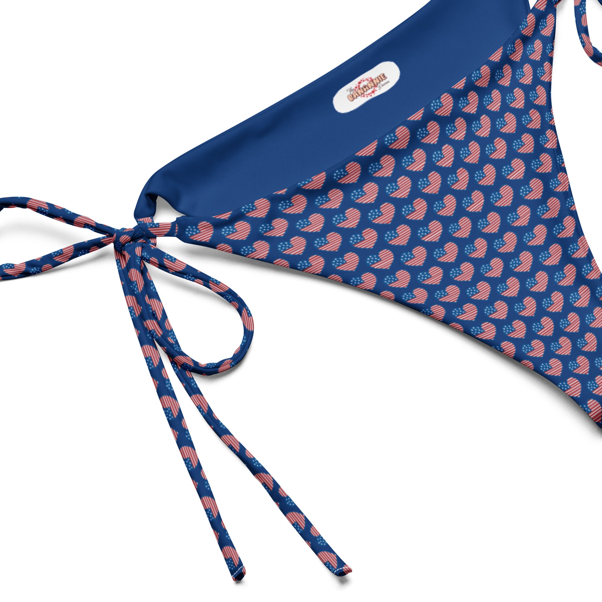 Discover our American Hearts All-Over Print Recycled String Bikini Bottom, a chic and sustainable swimwear option perfect for showing your patriotic spirit. Crafted from eco-friendly recycled materials, this bikini bottom features a stylish heart pattern in vibrant colors. Ideal for beach days or poolside lounging, its adjustable string ties ensure a perfect fit.